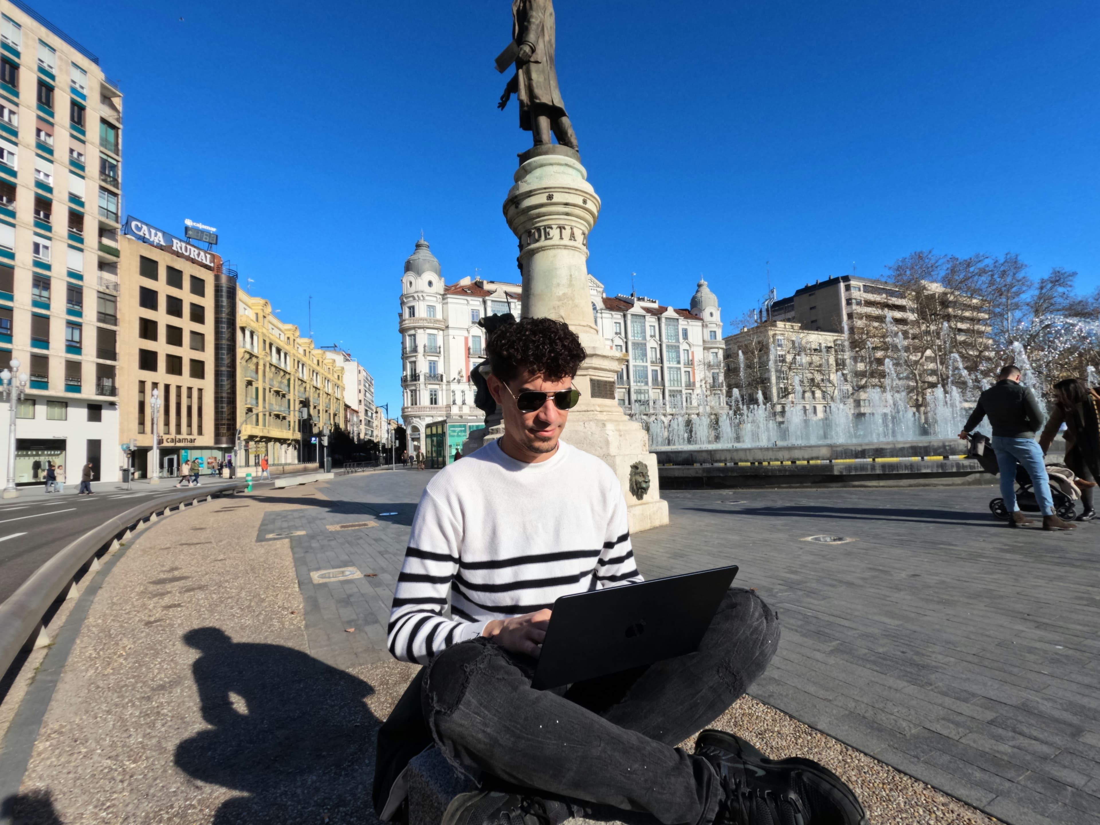 A man sitting on the floor and using laptop