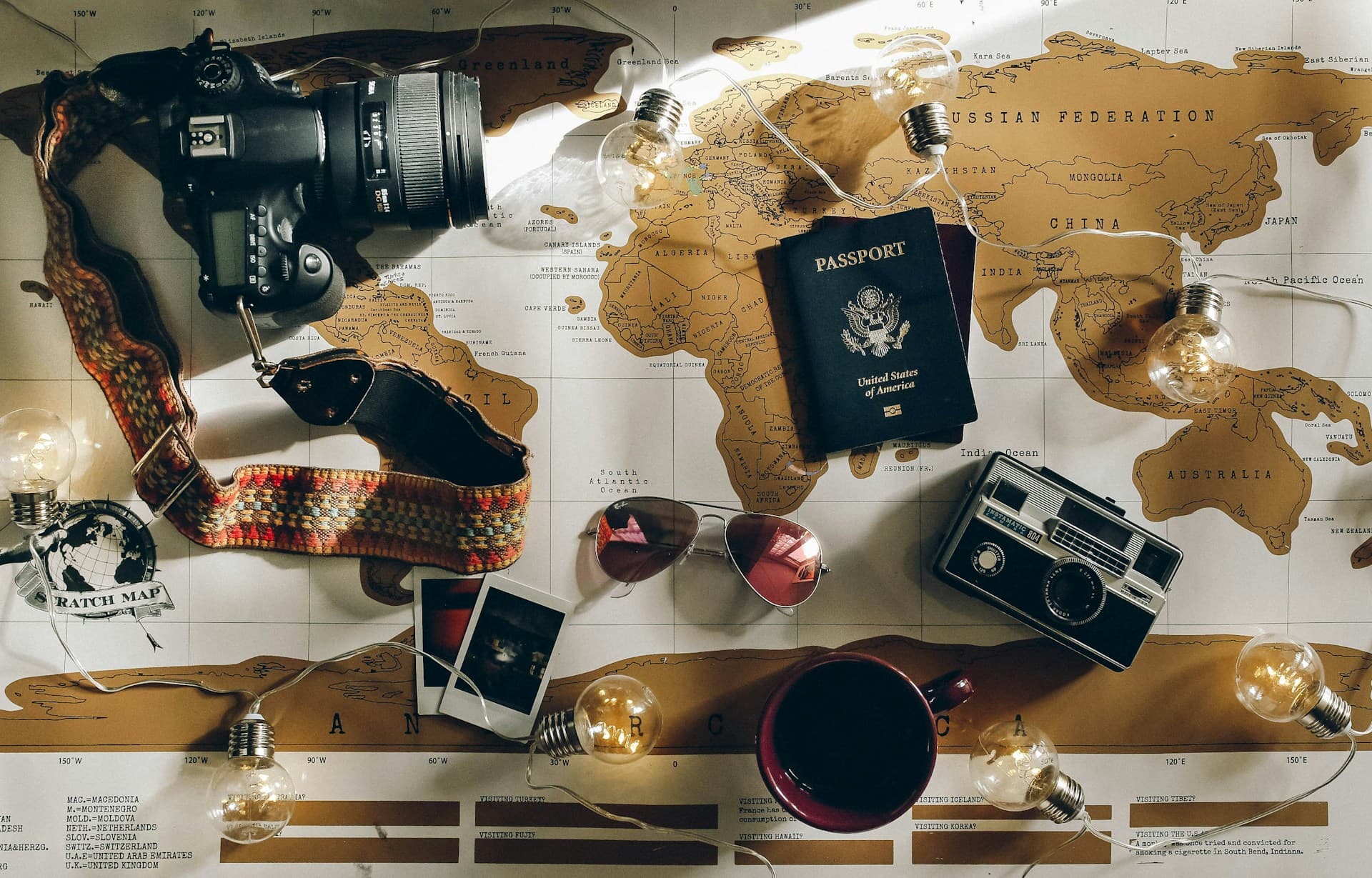 World map with pinned countries and a traveler journaling trip memories