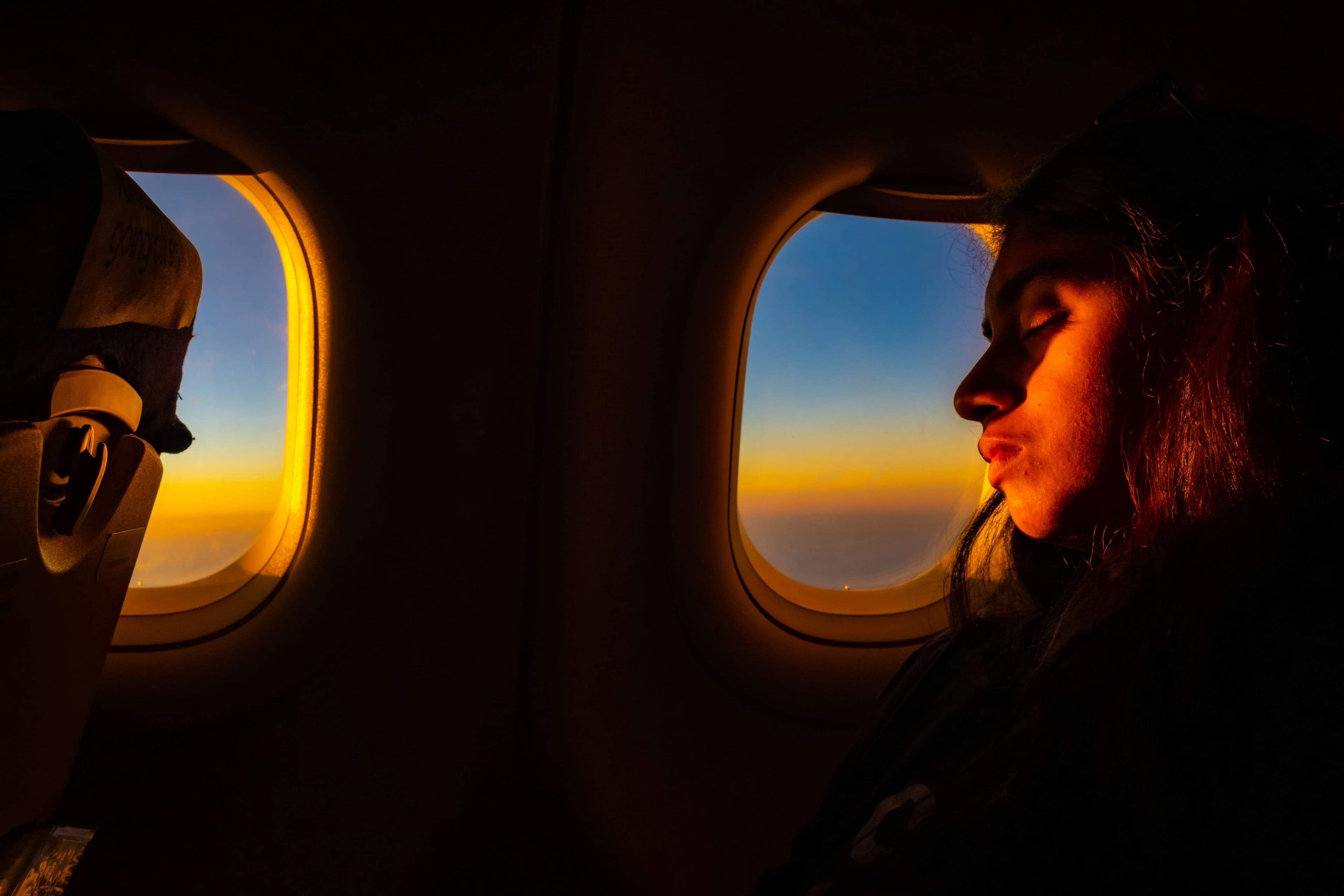Traveler resting near window seat